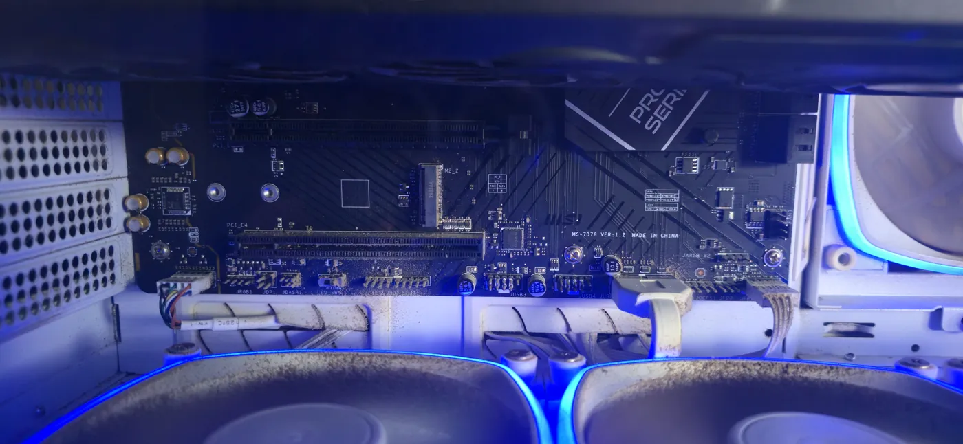 The motherboard installed and lit blue — an MSI MS-7D78 board, slots and headers visible.